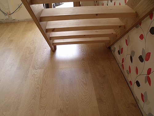  FITTING LAMINATE FLOORING UNDER THESE STAIRS WASN'T EASY